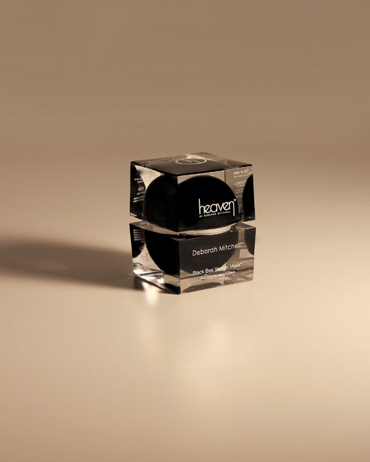 Cosmetic jar with black lid on a beige background