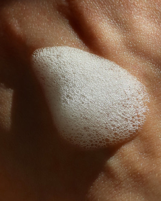 Close-up of foamed product on a hand.