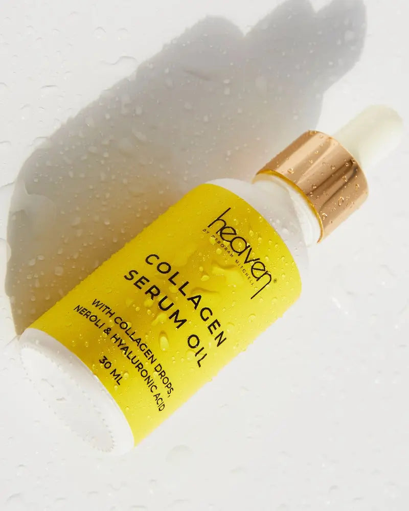 Collagen serum oil on white background with water hydration droplets covering it.