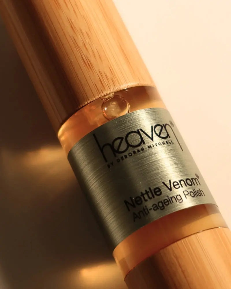 Bottle of 'Nettle Venom Anti-ageing Polish' by 'heaven' with wooden cap on a beige background