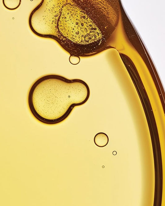 Close-up of oil with bubbles on a light yellow background